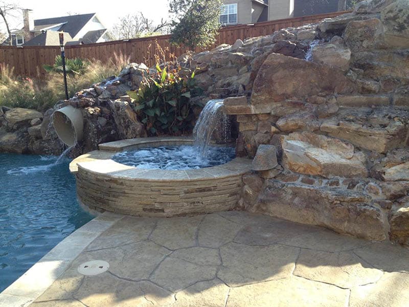 Hot Tub With Waterfall and Tunnel Slide